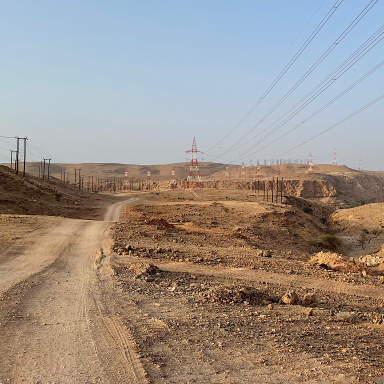 picture of track in the midst of some transmission lines